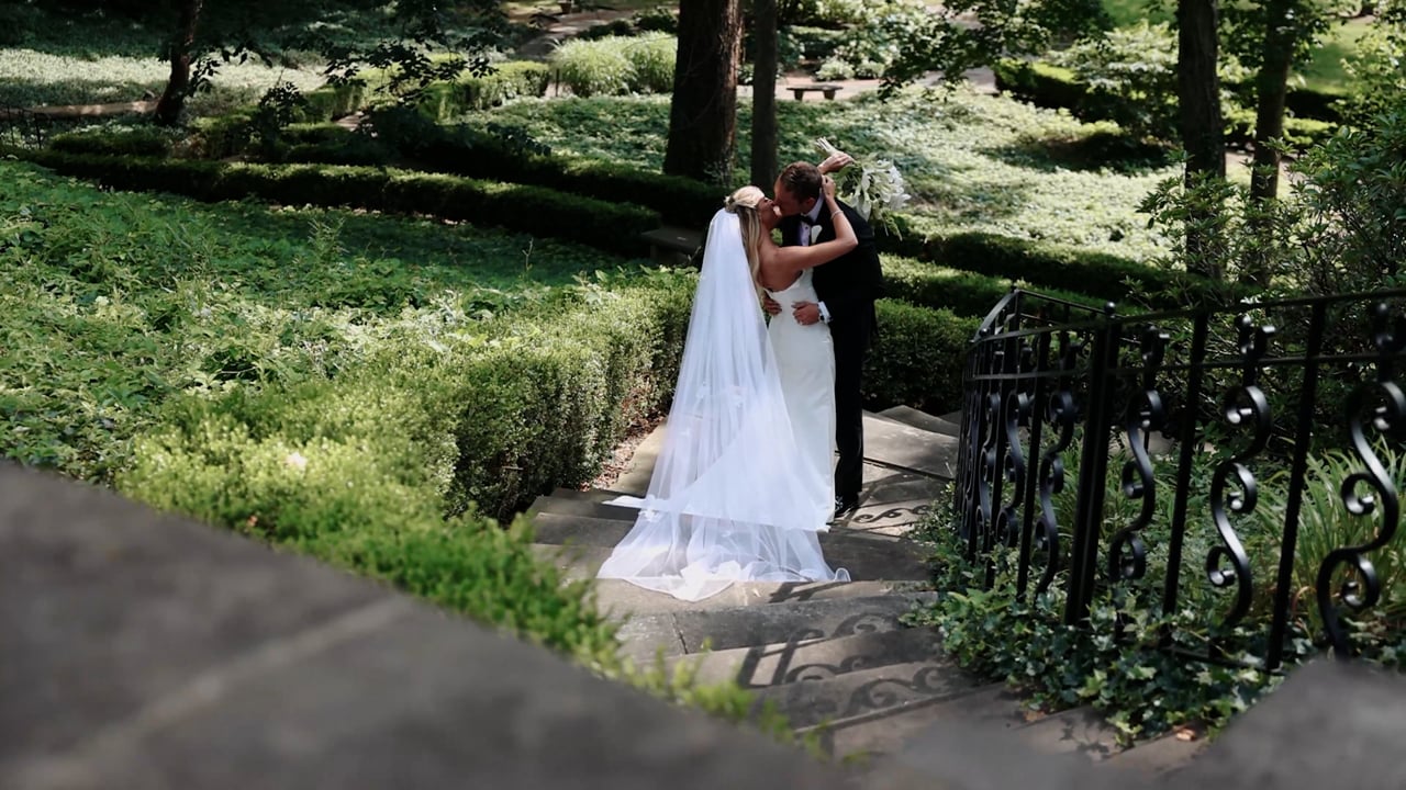 Alyssa and Matt sharing a quiet embrace in a garden